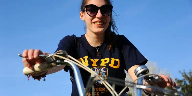 woman in black and yellow crew neck t-shirt riding bicycle during daytime